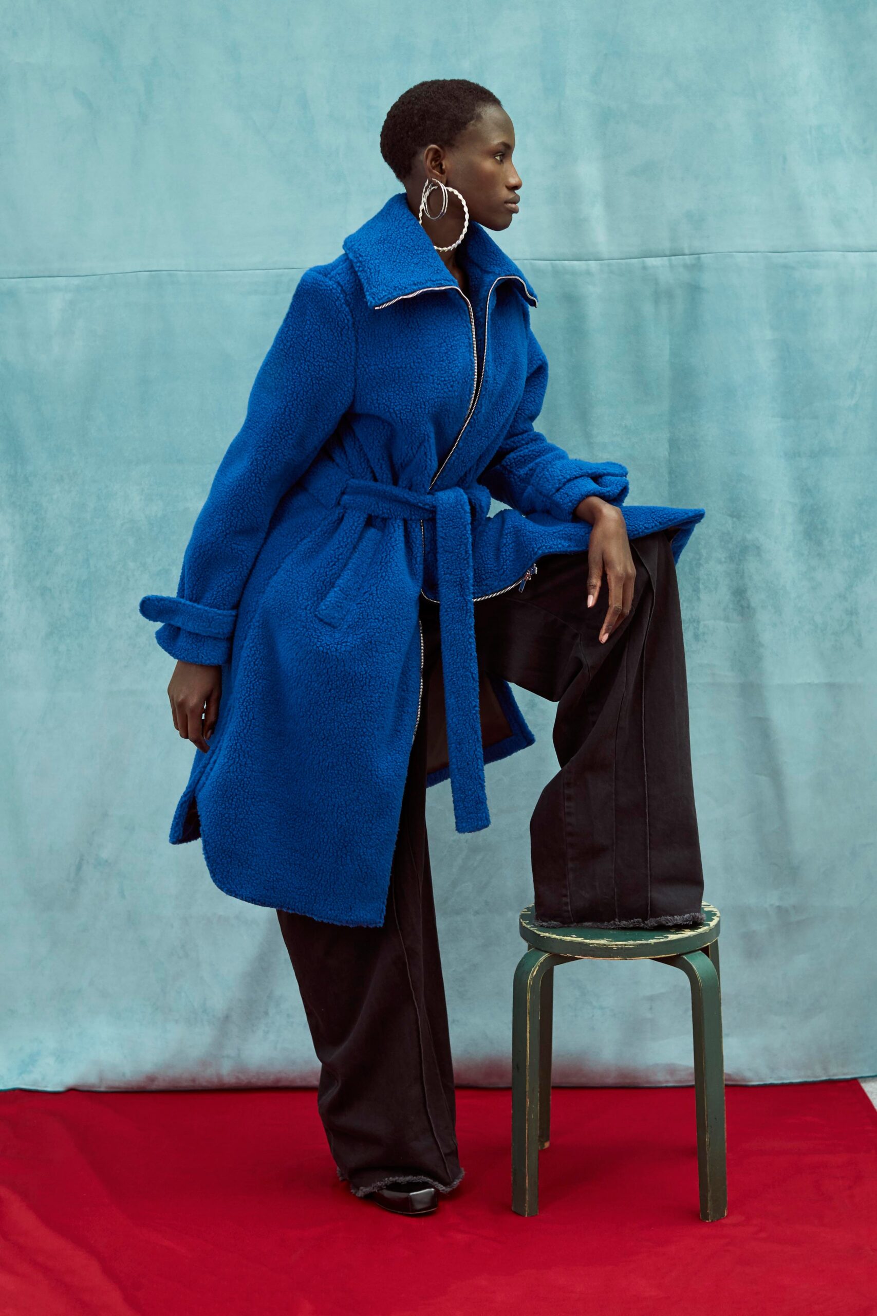 blue faux-fur coat and black pants