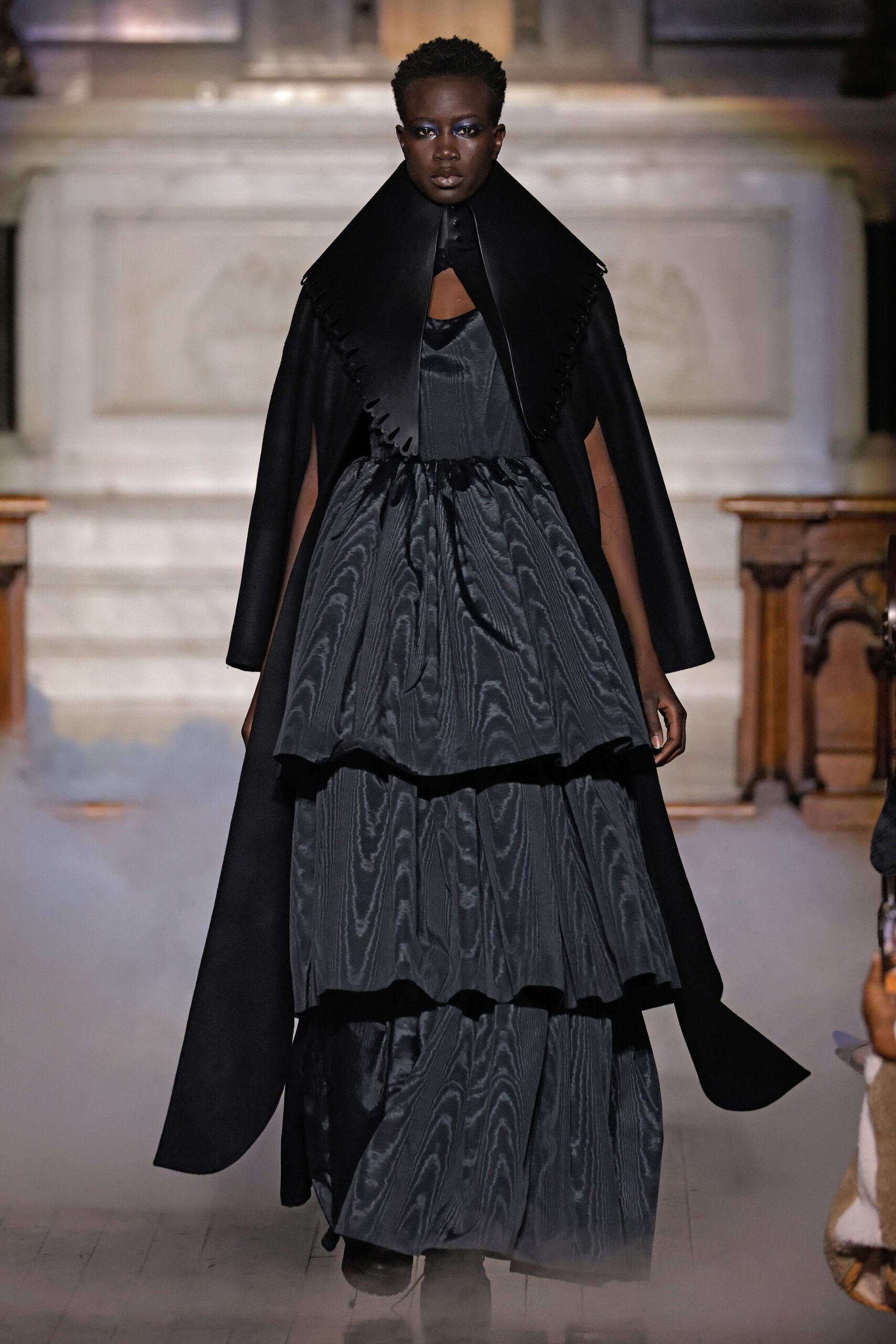 black silk tiered gown with cape