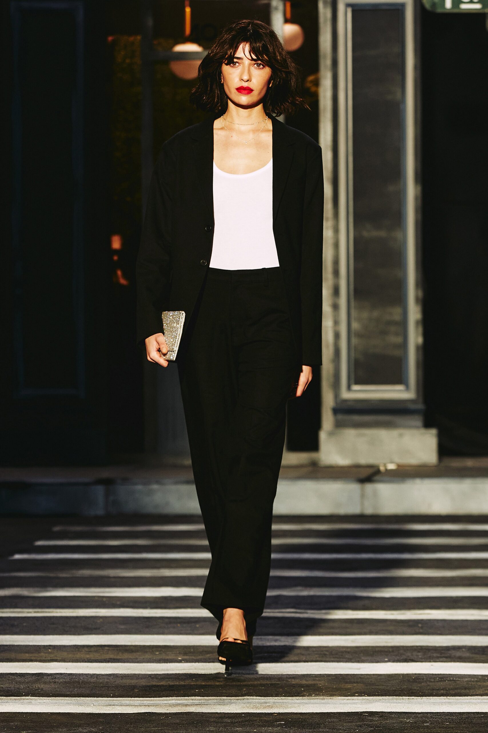A fitted black blazer paired with straight-leg pants, creating a sleek and sophisticated look.