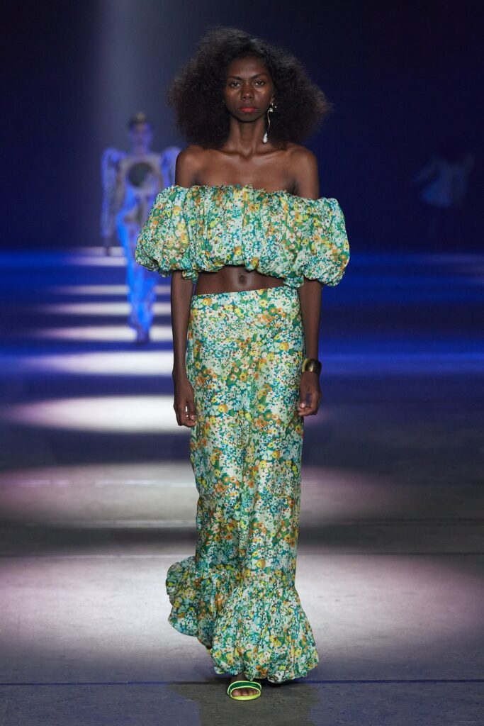 A fitted green floral off-shoulder dress with a flared silhouette.
