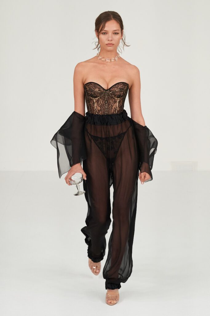 A fitted black sheer strapless jumpsuit with a layered design for a dramatic effect.