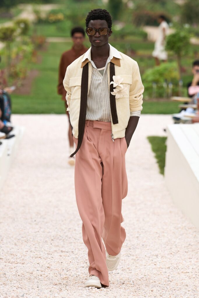 A relaxed beige cotton jacket with a collared neckline paired with straight-leg pink pants.