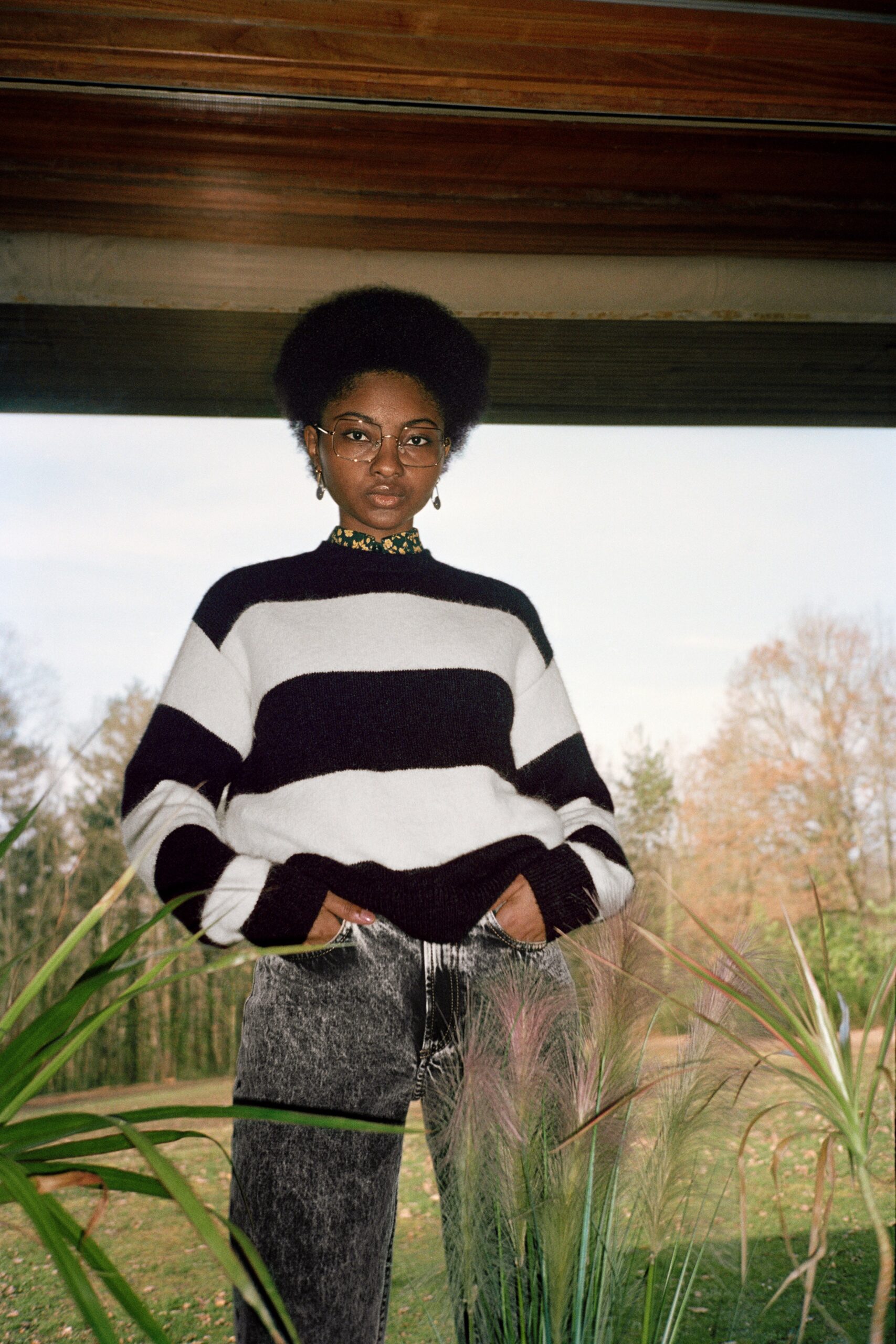 black and white striped sweater with gray pants