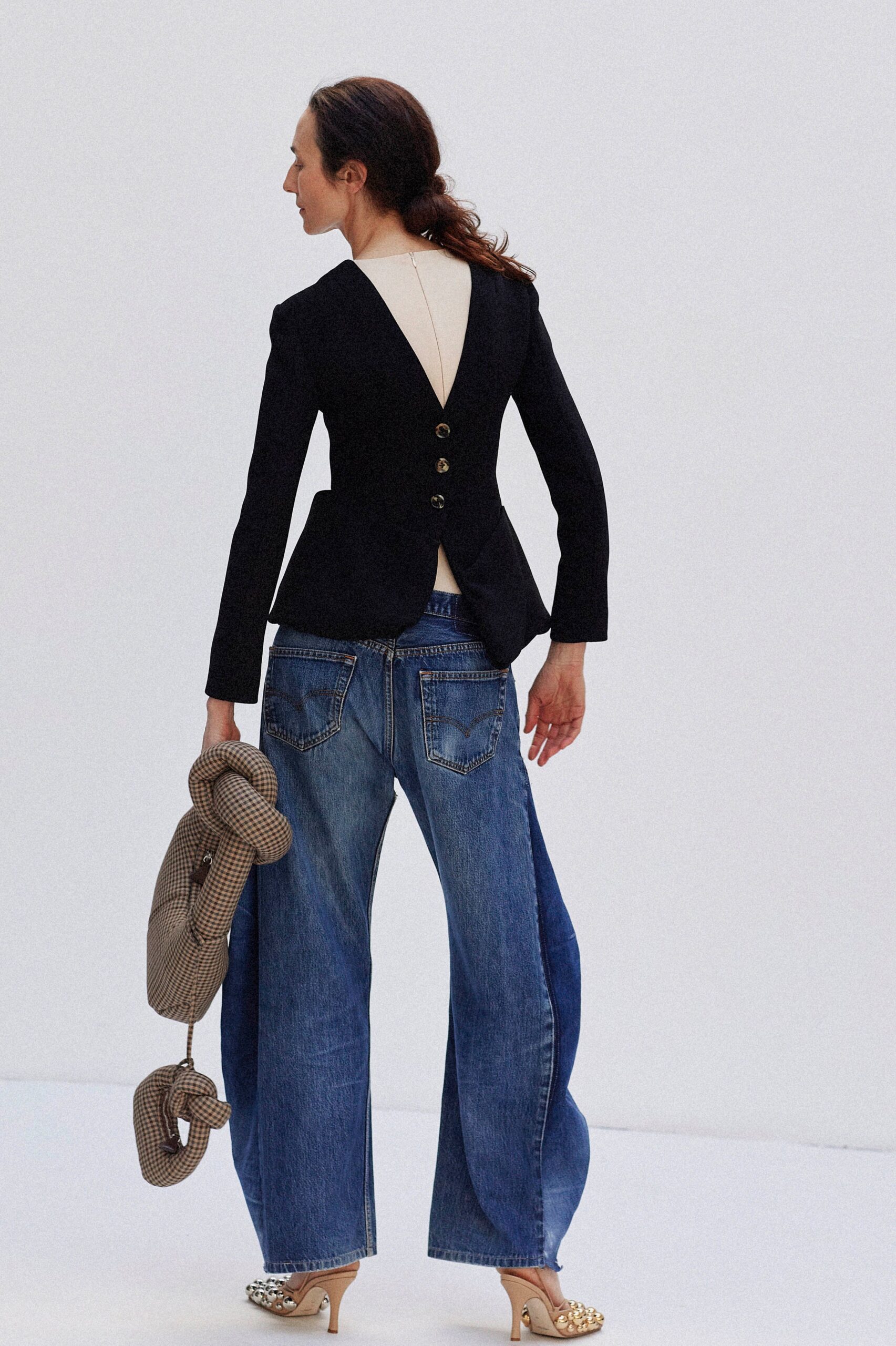 black tailored blazer with blue jeans