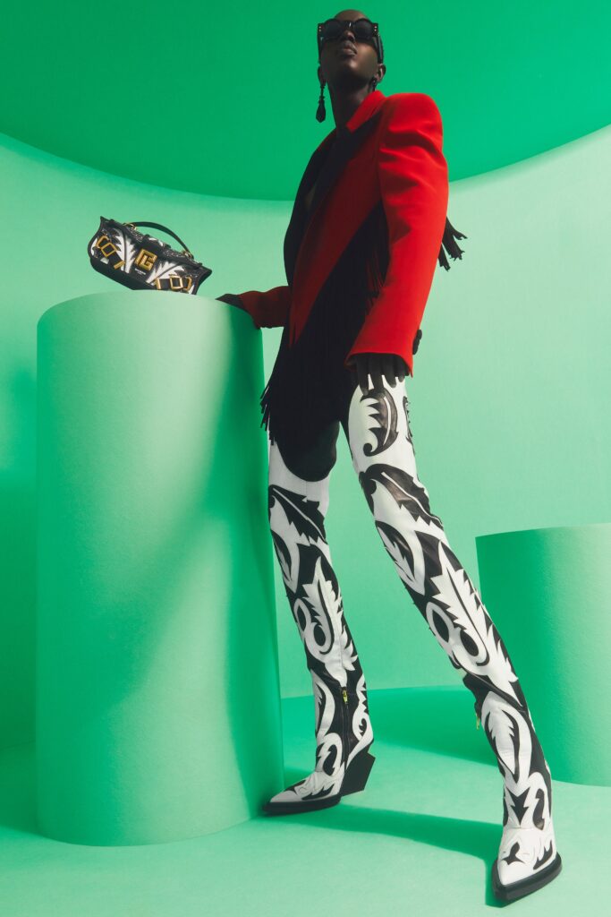 A fitted red jacket with long sleeves and printed flared pants in black and white.
