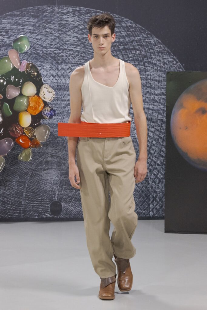 A relaxed beige cotton sleeveless top paired with orange belted pants featuring a straight-leg design.