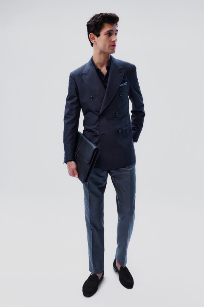 A tailored blue suit with a collared long-sleeve design and buttoned details.