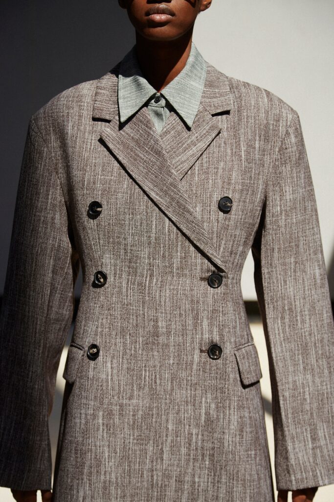 An oversized brown wool coat with long sleeves and a double-breasted design.