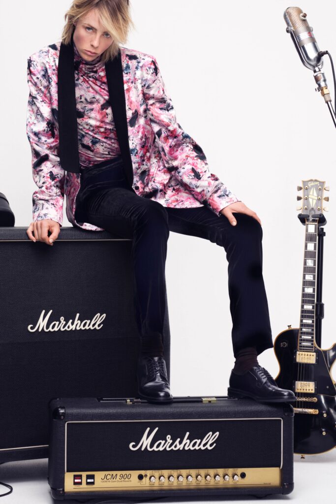A fitted pink printed jacket paired with black pants, showcasing a stylish and modern look.