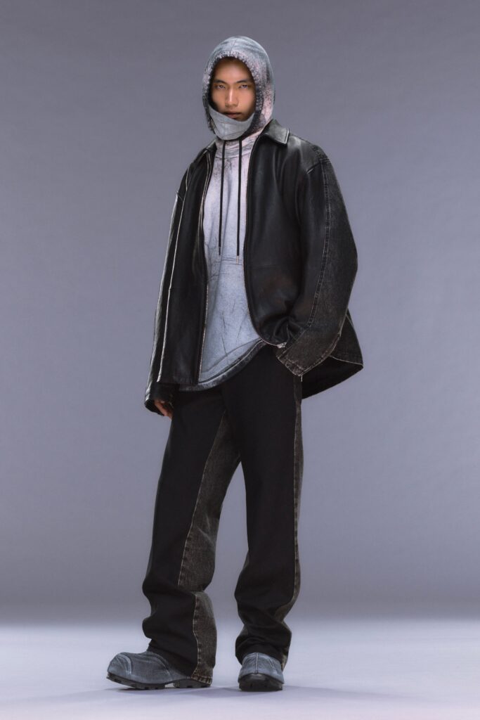 A relaxed black denim jacket paired with gray hooded layers and matching pants.