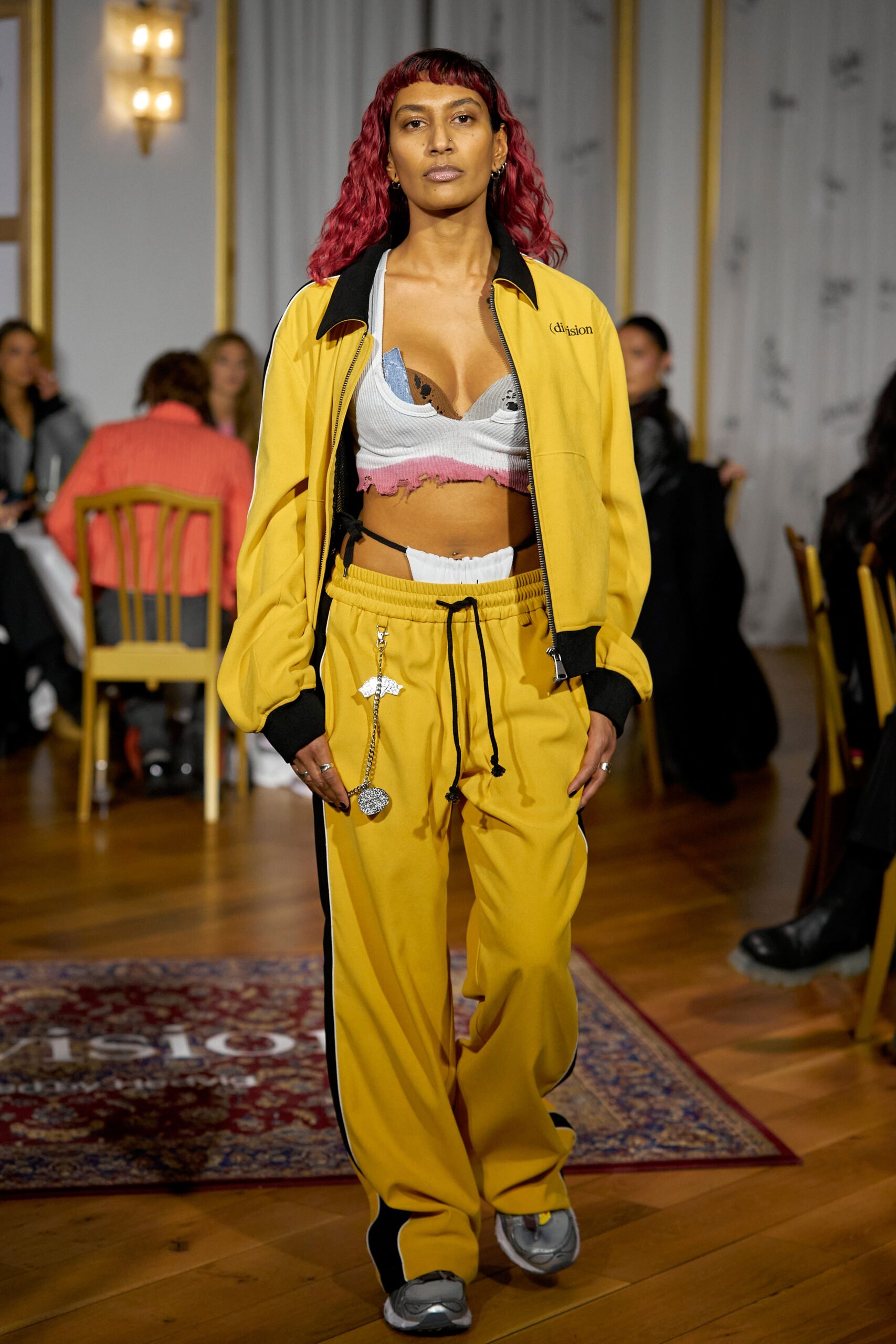 A relaxed yellow jacket with long sleeves and striped pants, perfect for a casual look.