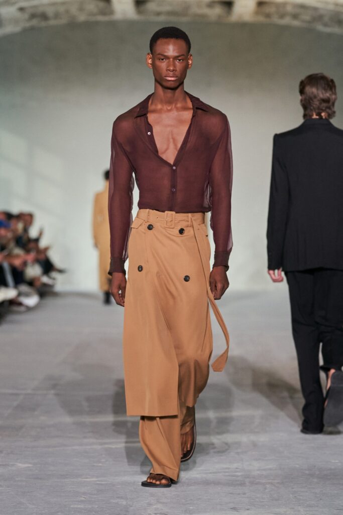A relaxed brown cotton long-sleeve shirt paired with beige wide-leg trousers.
