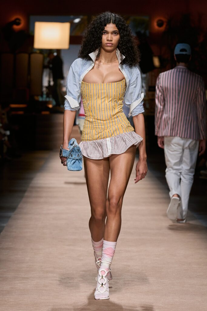 A fitted multicolor dress with a sleeveless design and pleated layered details.