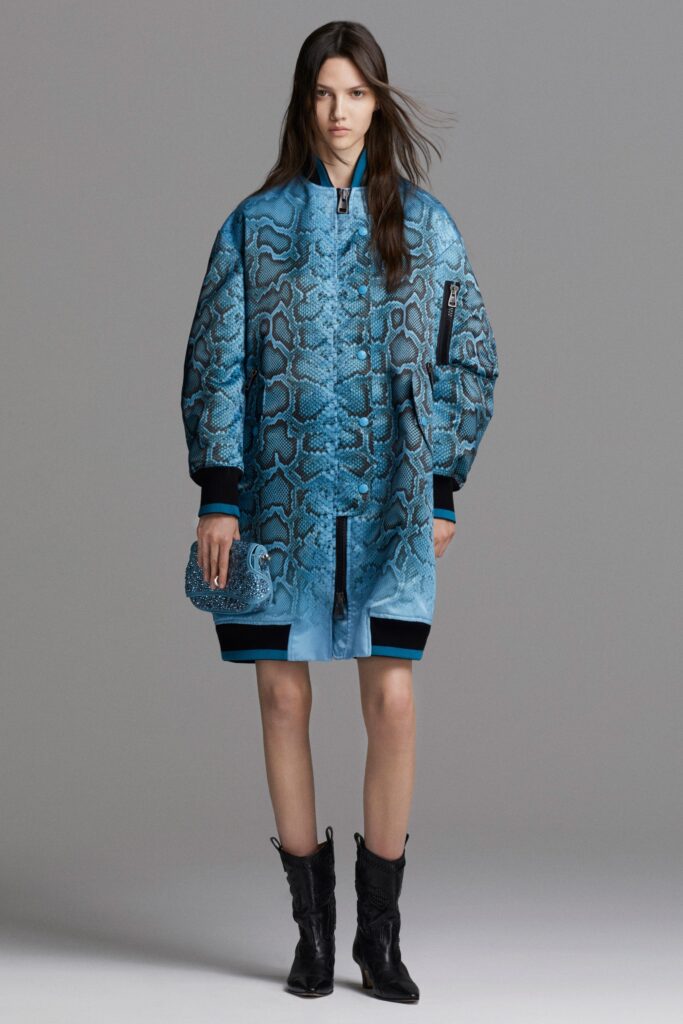 An oversized blue silk coat with long sleeves and a collared design featuring a printed texture.