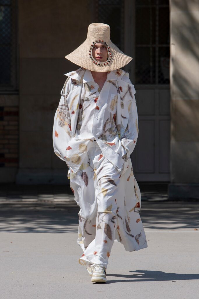 A relaxed white dress with a long-sleeve collared jacket featuring a printed design.
