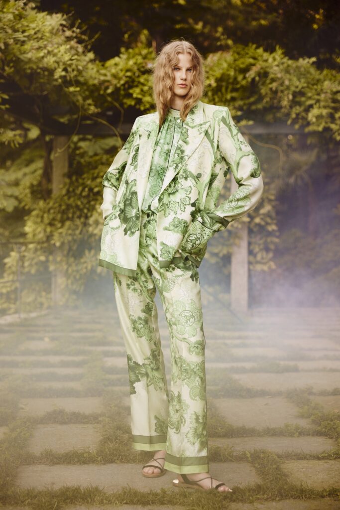A relaxed green silk suit with long sleeves and a collared design featuring a printed pattern.