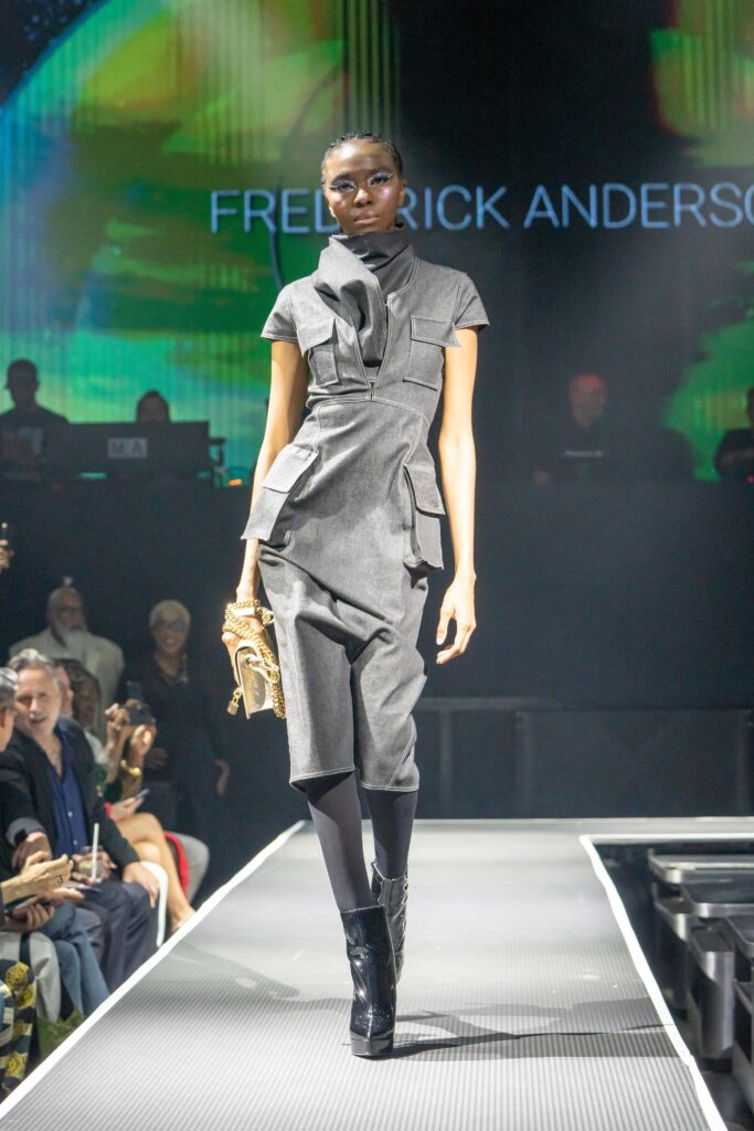A fitted gray cotton dress with a high neckline and asymmetric design details.