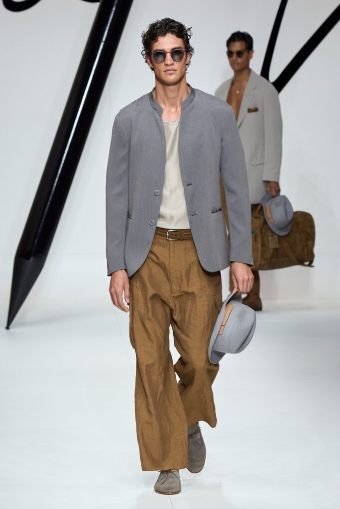 A relaxed gray long-sleeve jacket paired with wide-leg brown pants.