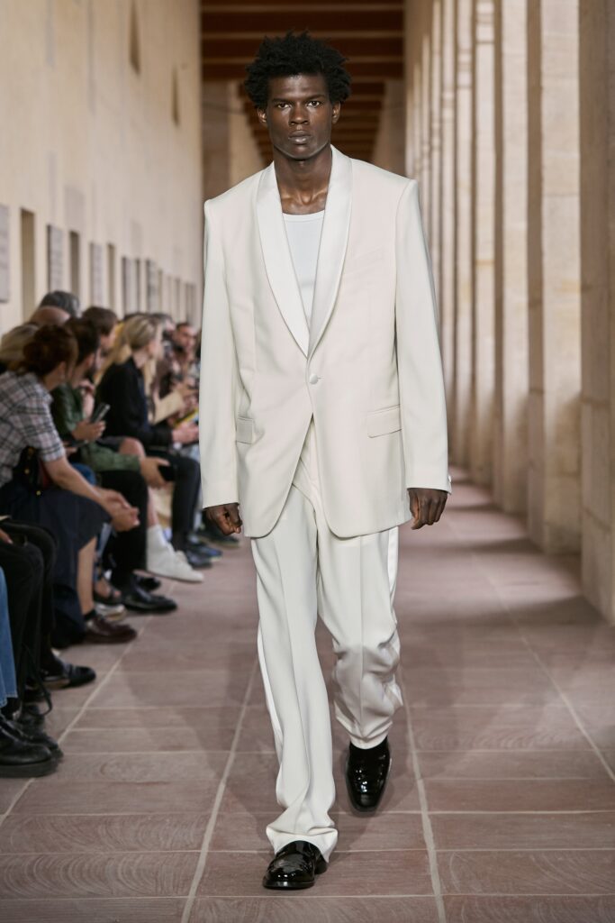 A tailored white suit featuring a collared long-sleeve jacket and straight-leg pants.