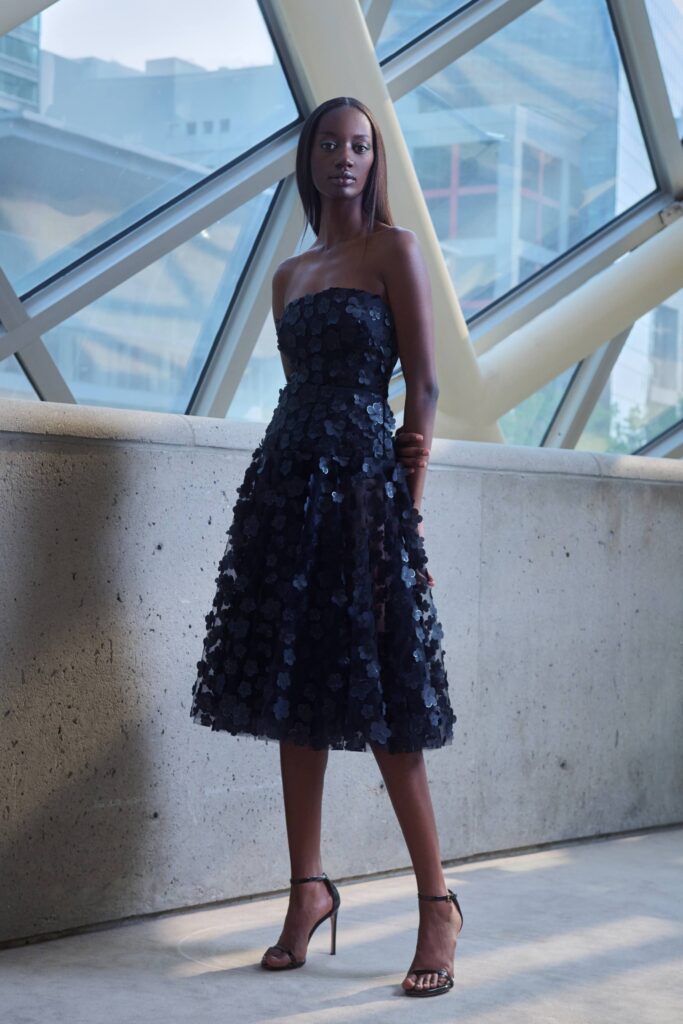 A fitted black silk strapless dress with pleated detailing for a sophisticated look.