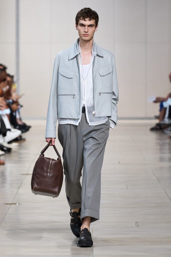 A relaxed gray cotton jacket paired with straight-leg pants, featuring a collared design.