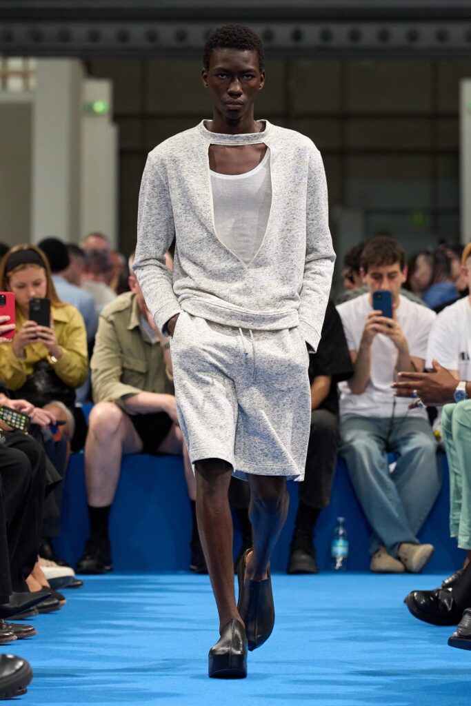 A relaxed fit gray cotton top with a V-neck and matching shorts, layered for a stylish look.