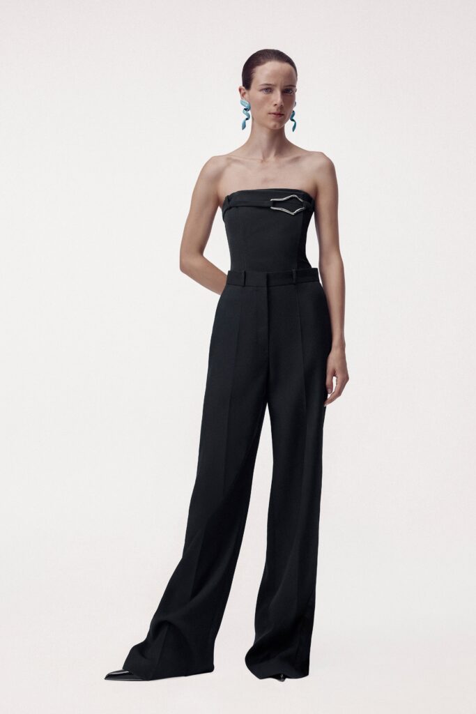A fitted black strapless jumpsuit with a straight-leg silhouette and minimalistic design.