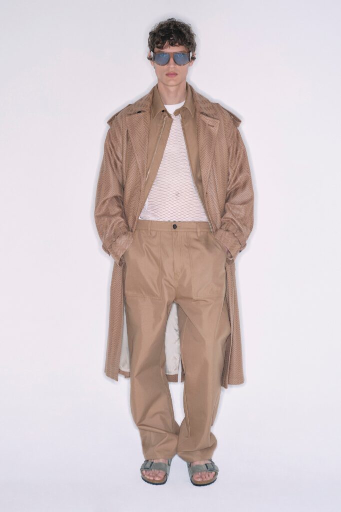 A relaxed beige cotton coat with long sleeves and collared design, paired with matching pants.
