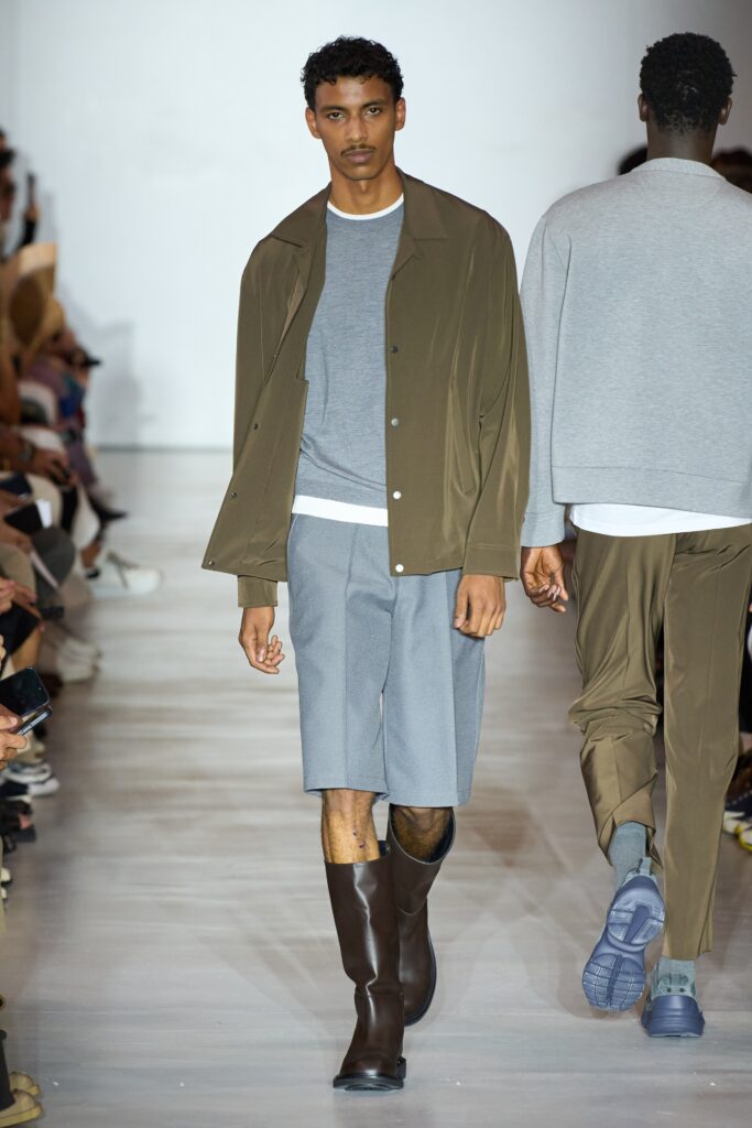 A relaxed gray cotton jacket paired with brown shorts, featuring a collared neckline and buttoned detail.