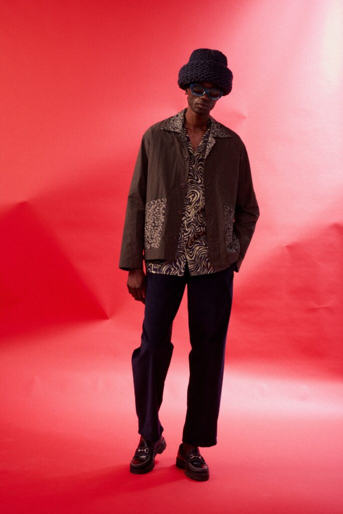 A relaxed brown jacket layered over a printed long-sleeve shirt, perfect for a casual look.