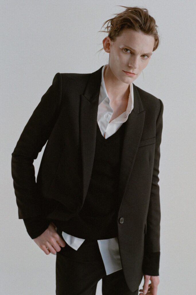 A fitted black blazer worn over a collared white shirt, showcasing a modern and stylish look.