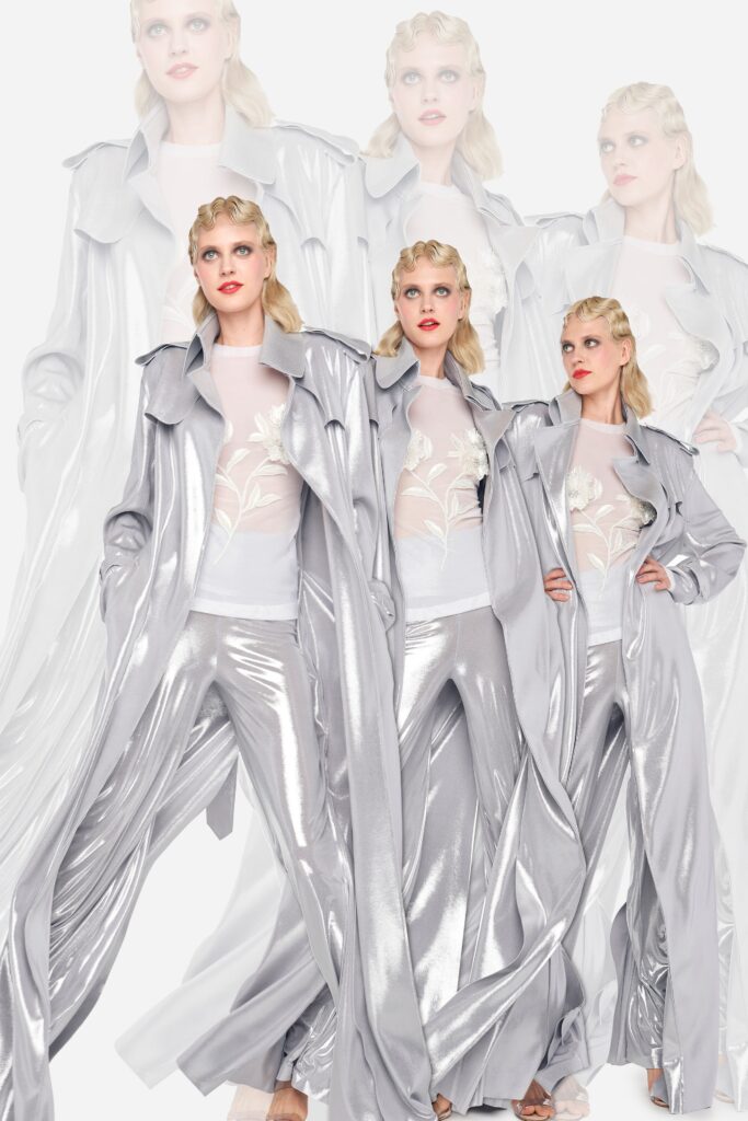 A relaxed silver silk coat with long sleeves and wide-leg pants.