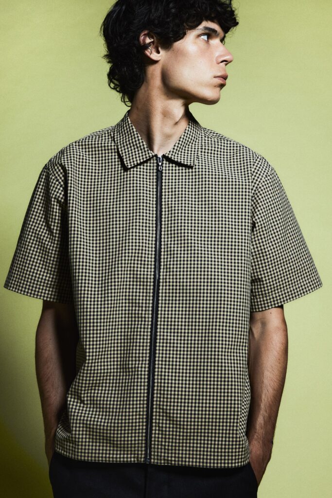 A relaxed brown checked short-sleeve shirt with a collared neckline.
