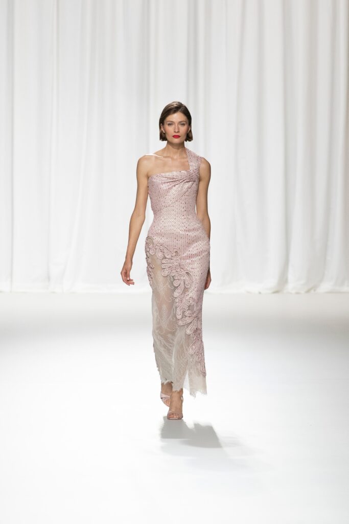 A fitted pink silk gown with a sleeveless design and intricate embroidery.