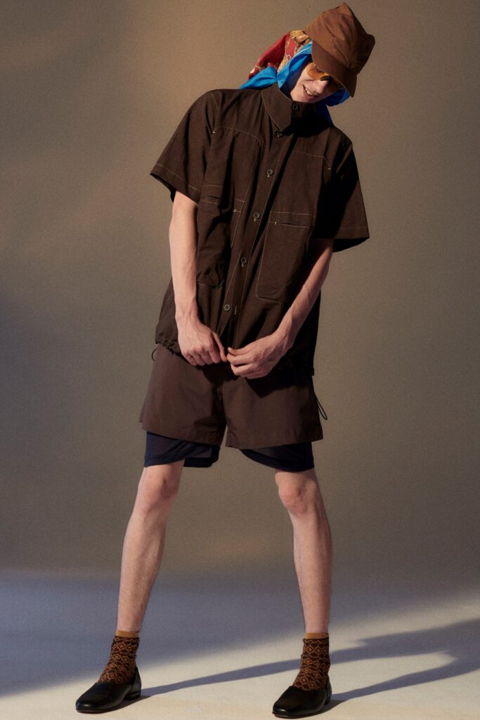A relaxed brown cotton shirt with short sleeves and matching shorts, featuring a buttoned design.