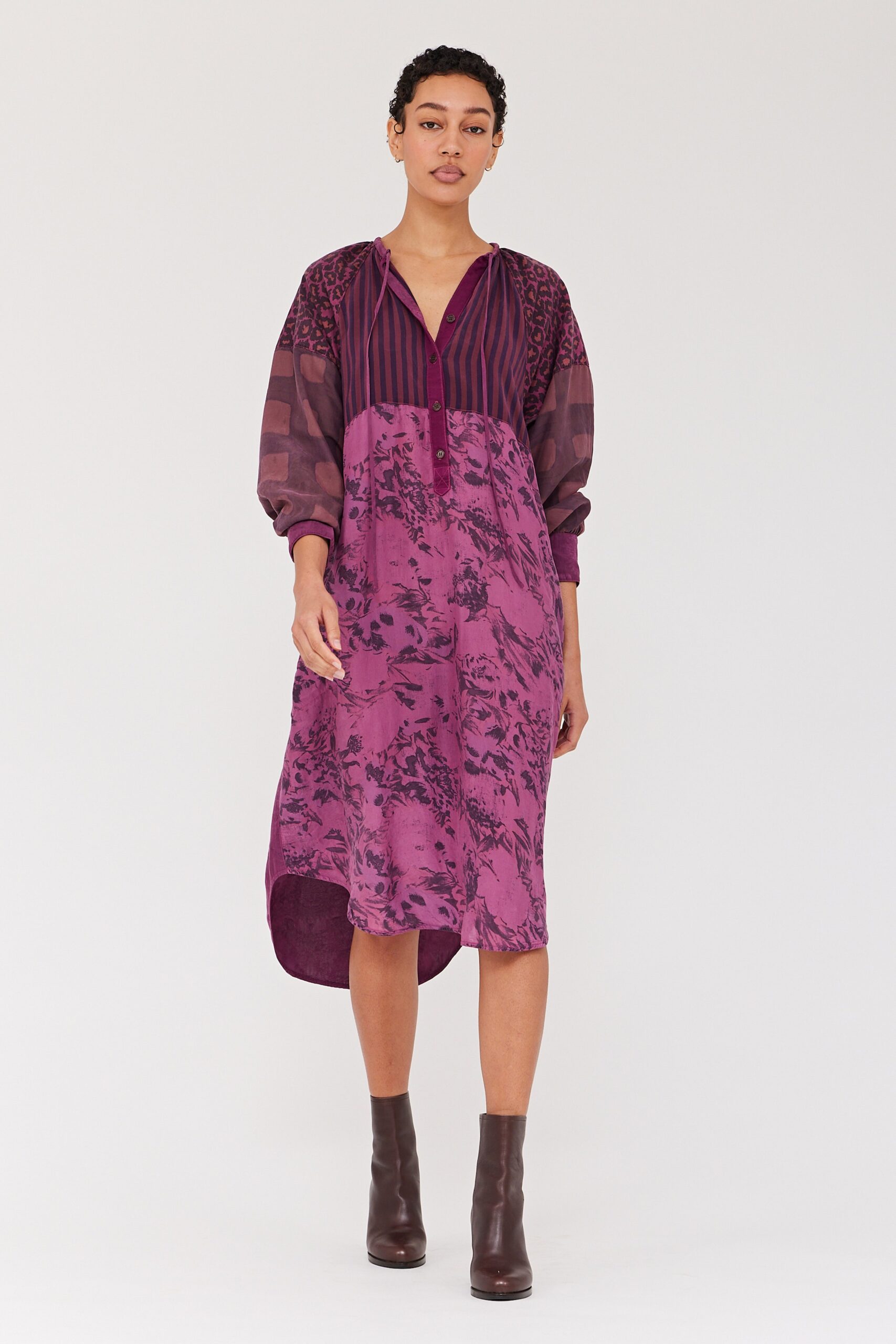 A relaxed purple dress with long sleeves, a collared neckline, and an asymmetric hemline.