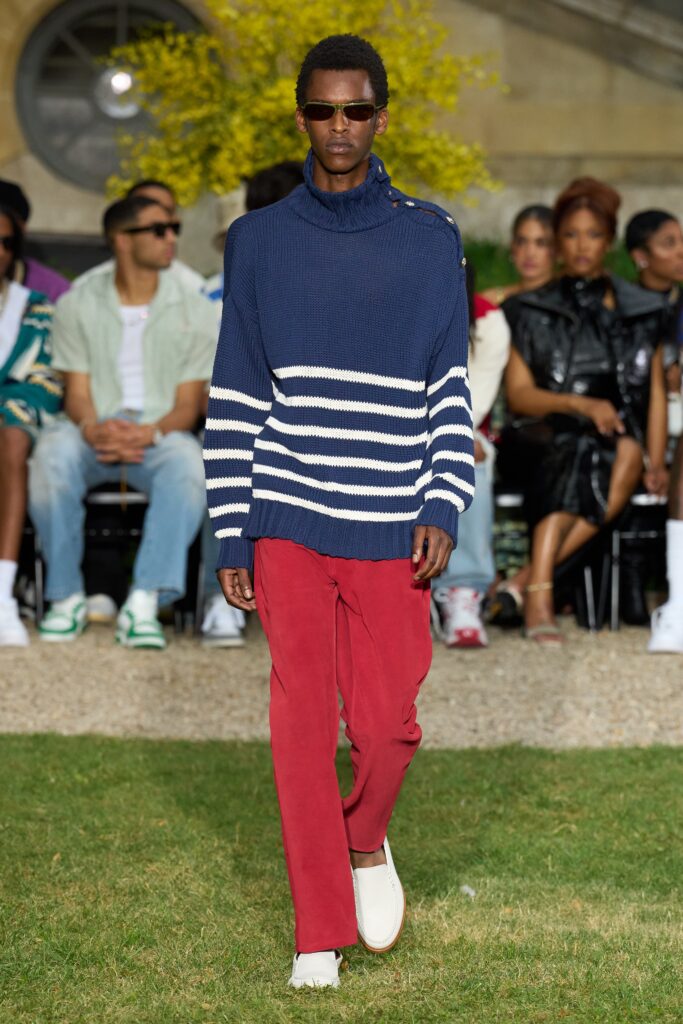 A relaxed blue striped sweater paired with red pants, featuring a collared design.