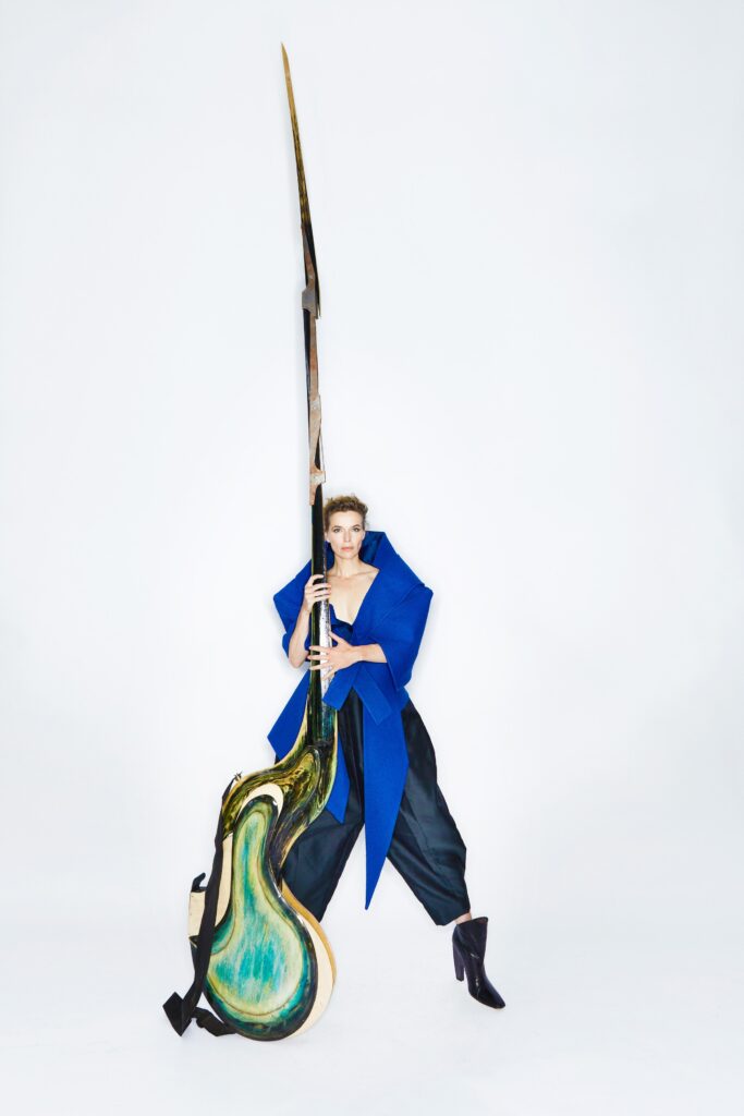 A relaxed blue asymmetric jacket paired with black relaxed-fit pants.