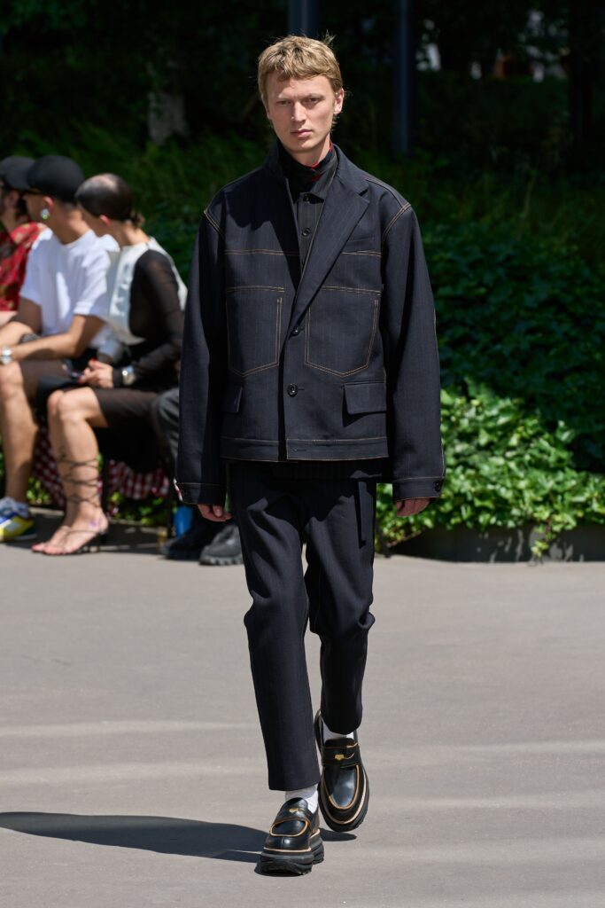 A relaxed black jacket with long sleeves and collared design paired with straight-leg pants.