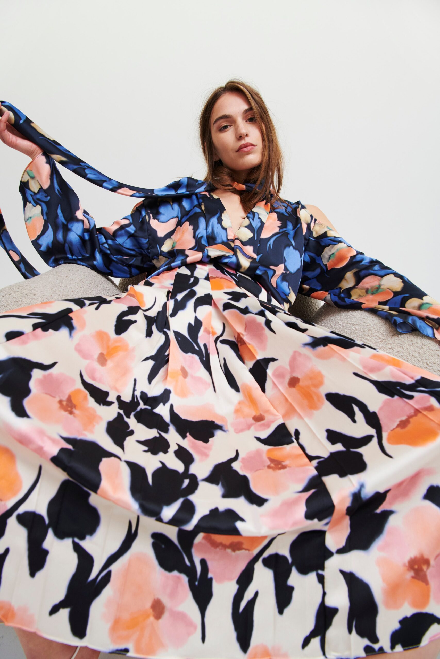 A relaxed floral silk dress with long sleeves and a V-neckline, featuring a flared silhouette.