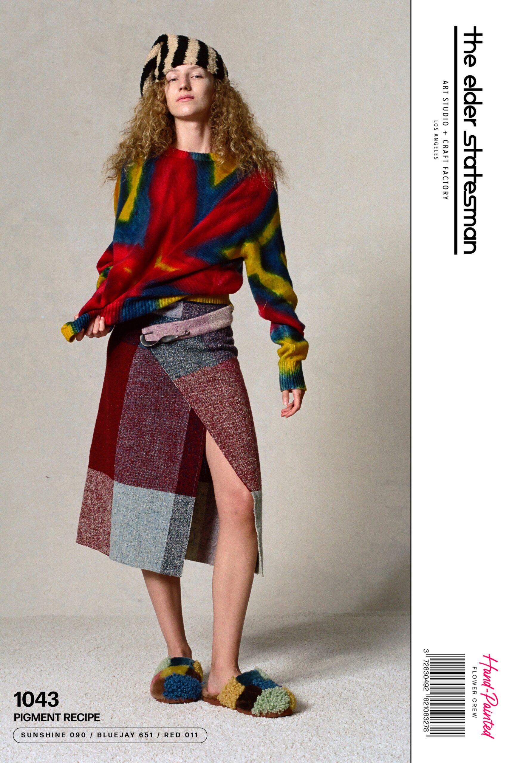 A relaxed multicolor wool sweater with long sleeves paired with an asymmetric layered skirt.