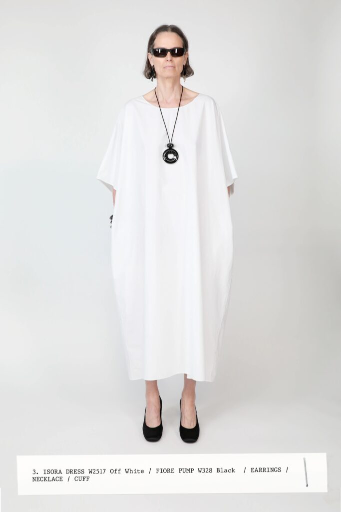A relaxed white cotton dress with a sleeveless design and straight silhouette.