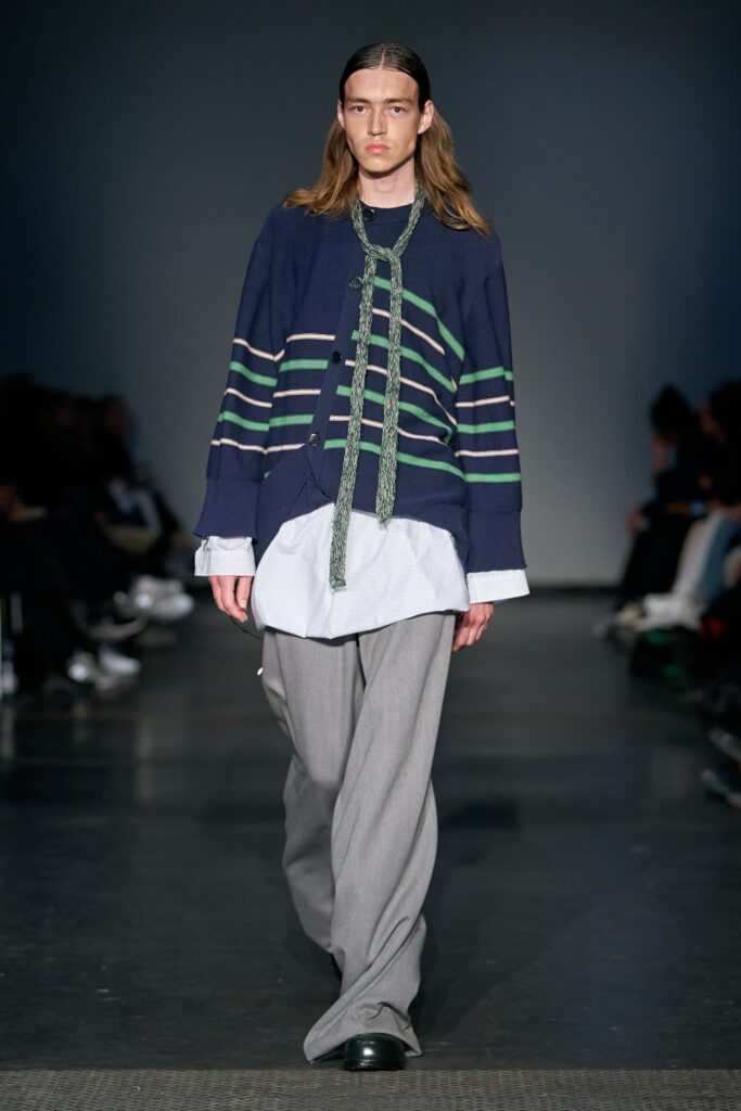 A relaxed blue striped jacket paired with wide-leg gray pants for a contemporary look.