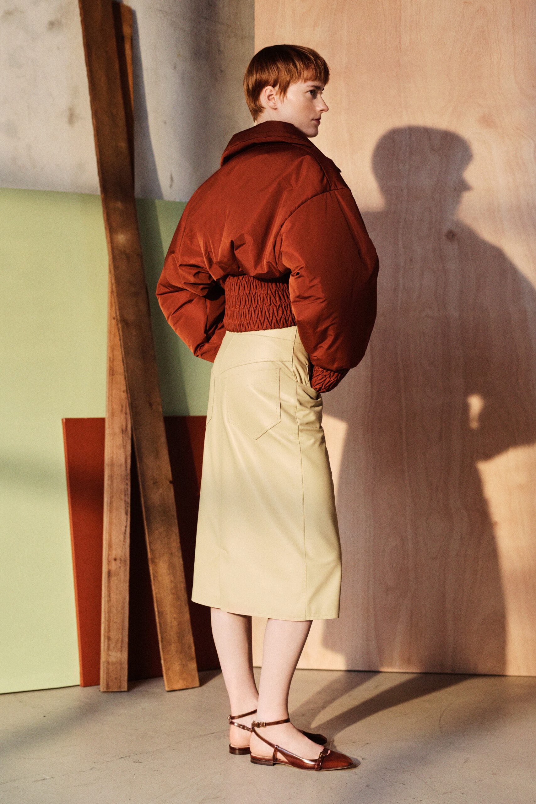 oversized brown jacket with fitted yellow skirt