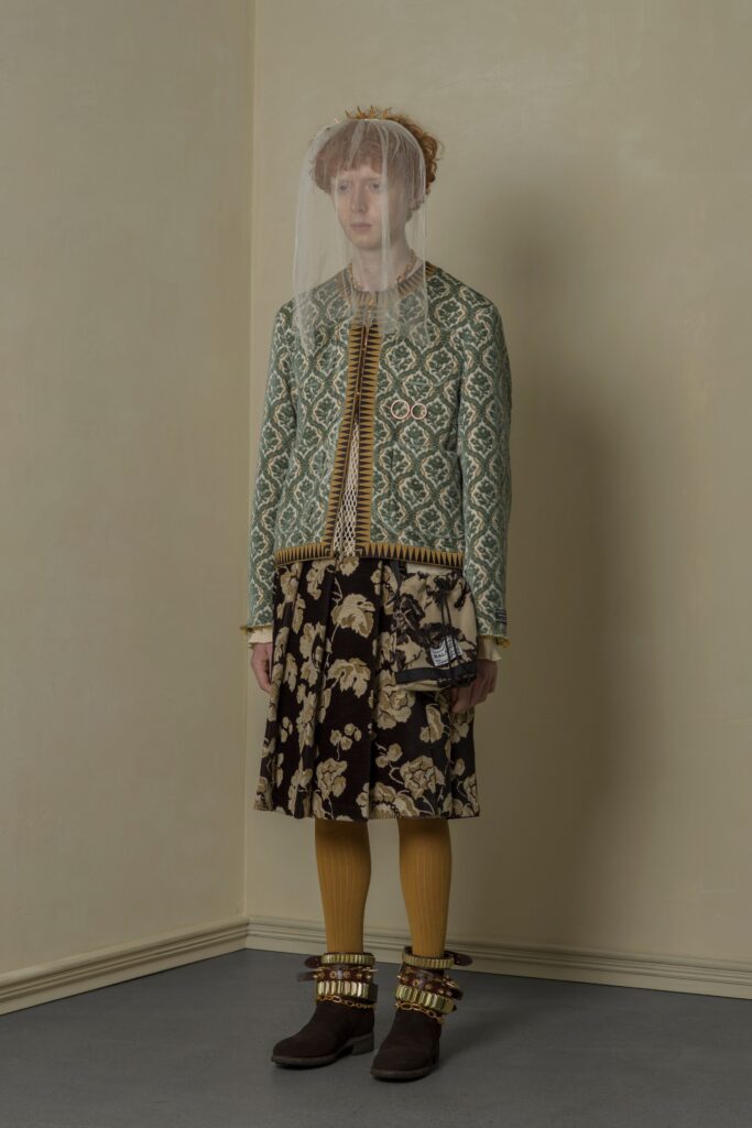 A relaxed fit green floral jacket paired with a flared skirt in brown and yellow tones.