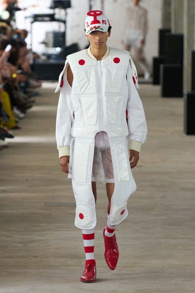 A relaxed white leather jacket with long sleeves and color-blocked pants.