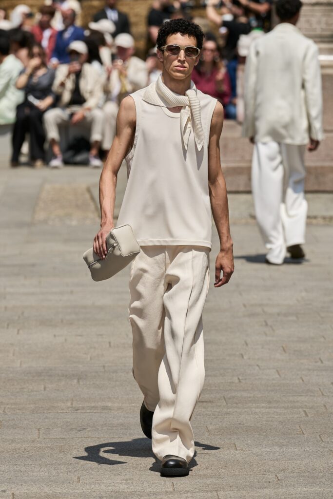 A relaxed beige sleeveless top paired with straight-leg pants for a chic look.