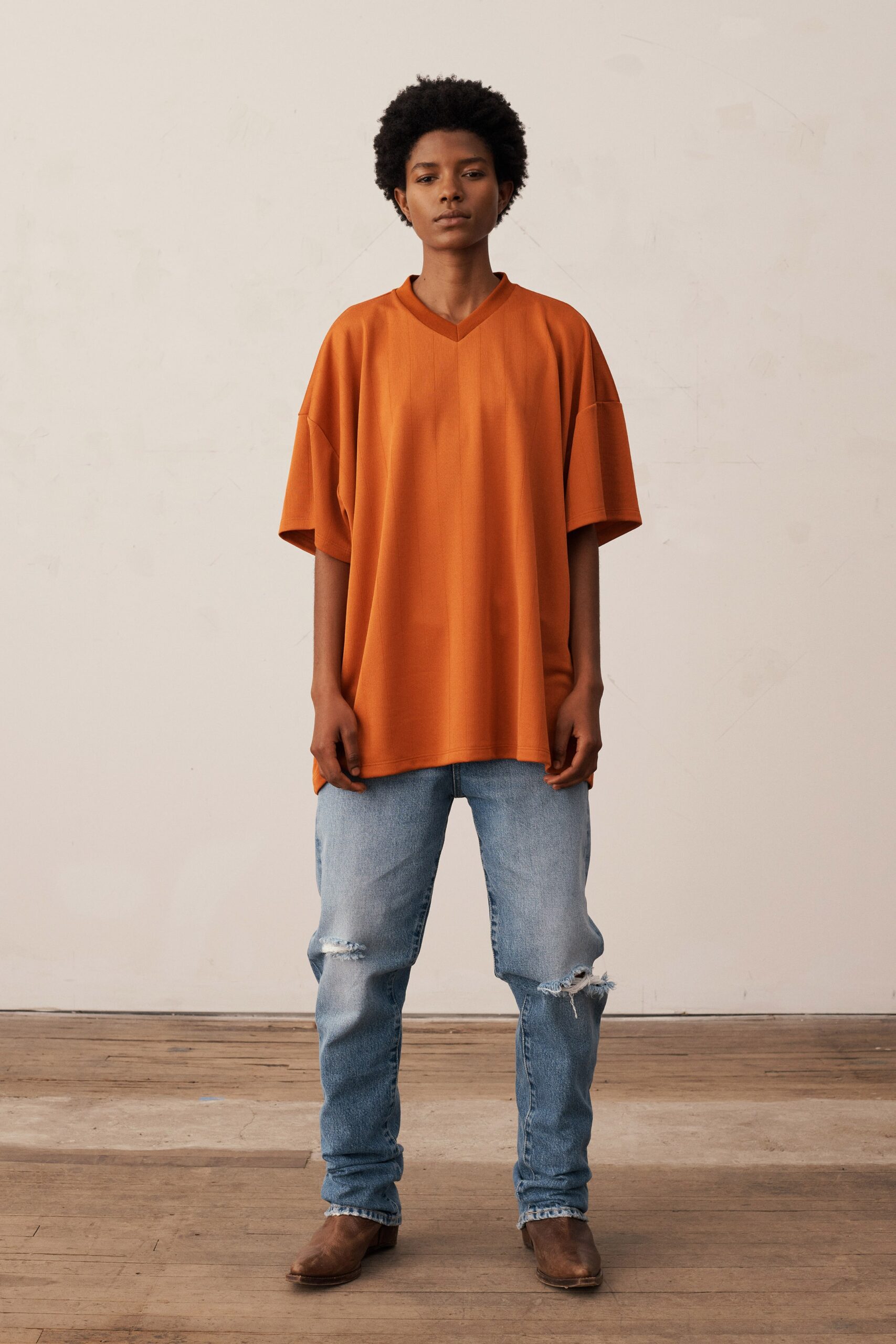 orange relaxed top with blue jeans