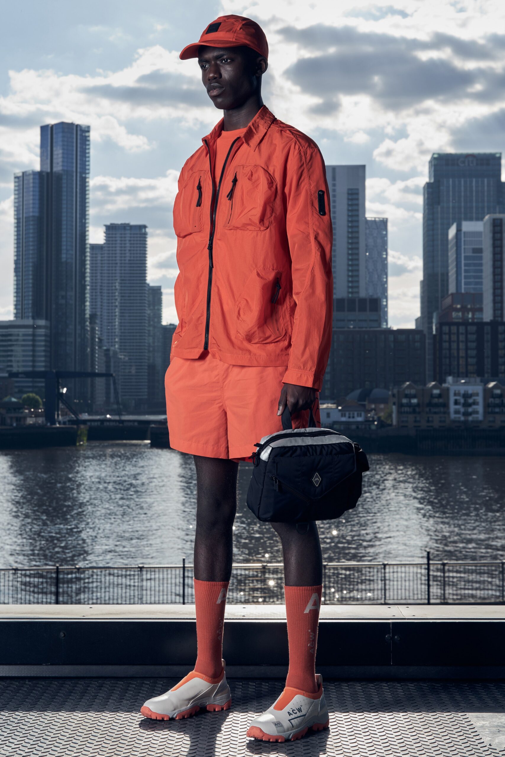 A relaxed orange jacket with short sleeves paired with matching shorts, perfect for a sporty look.