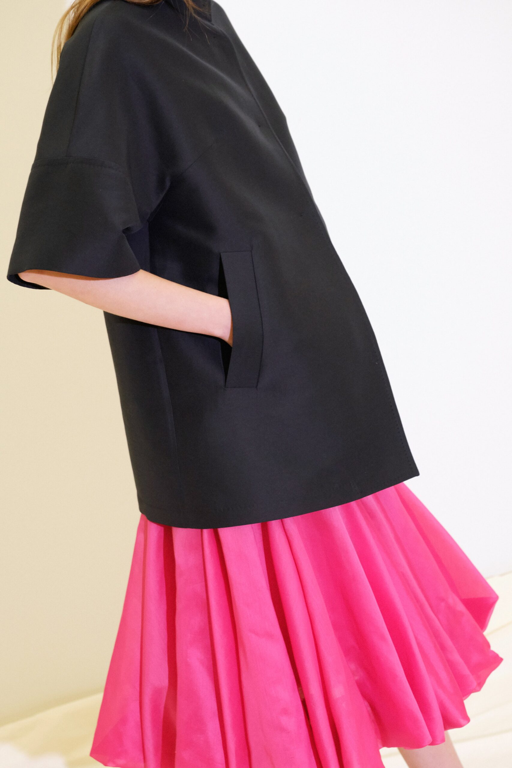 black top with pink pleated skirt